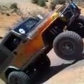Jeep Climbs Up A Steep Rock 
