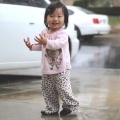 Toddler Playing In The Rain For First Time